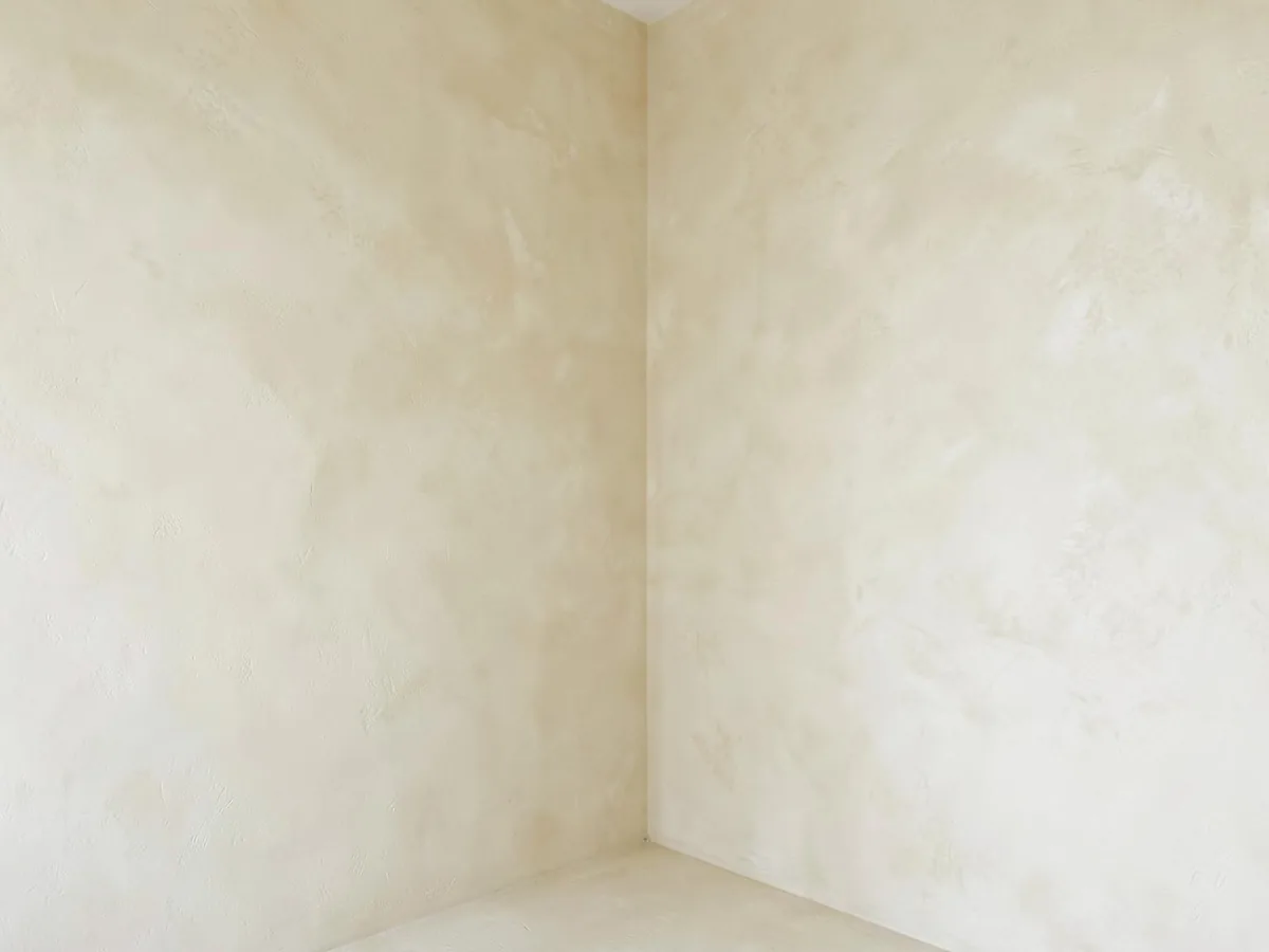 Chalky cream limewash finish on two interior walls meeting at a corner