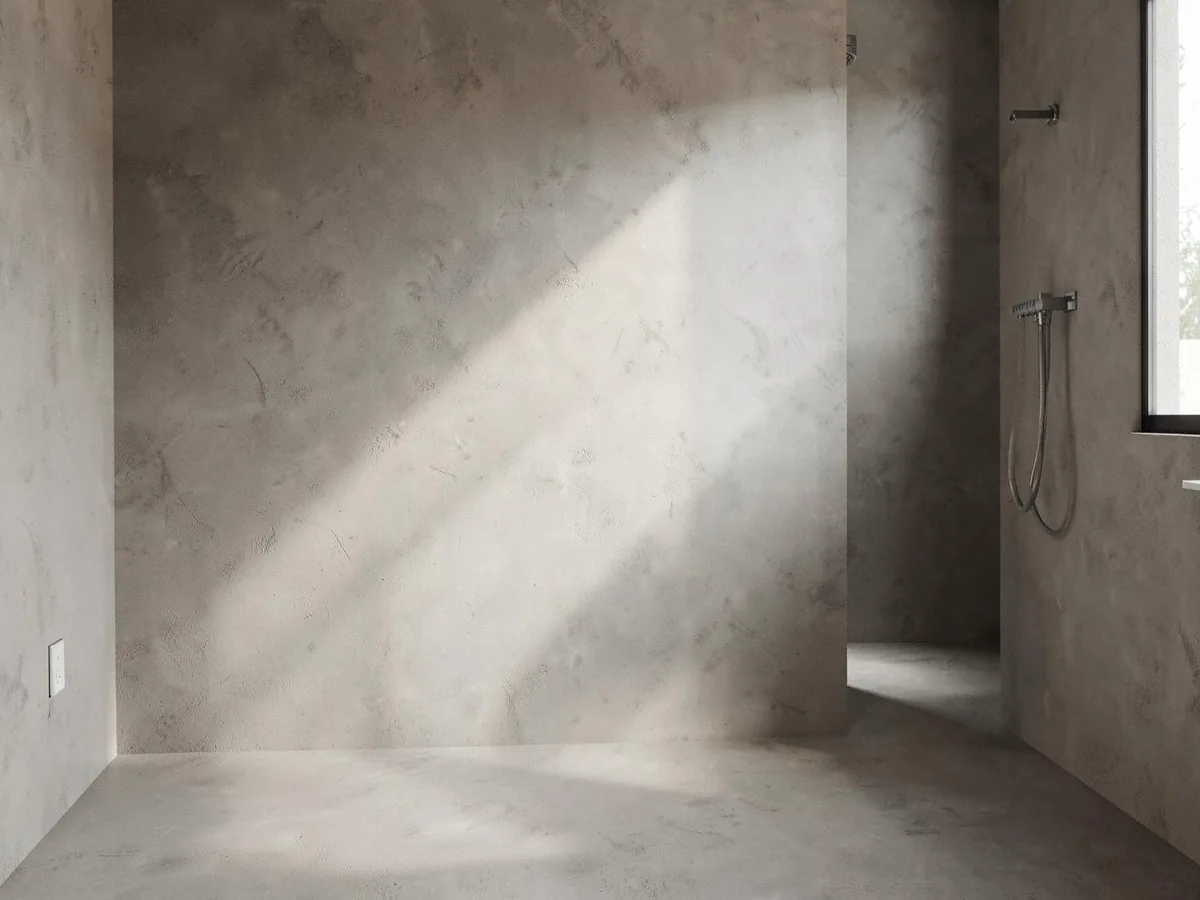 Seamless warm grey microcement wall finish in a contemporary bathroom