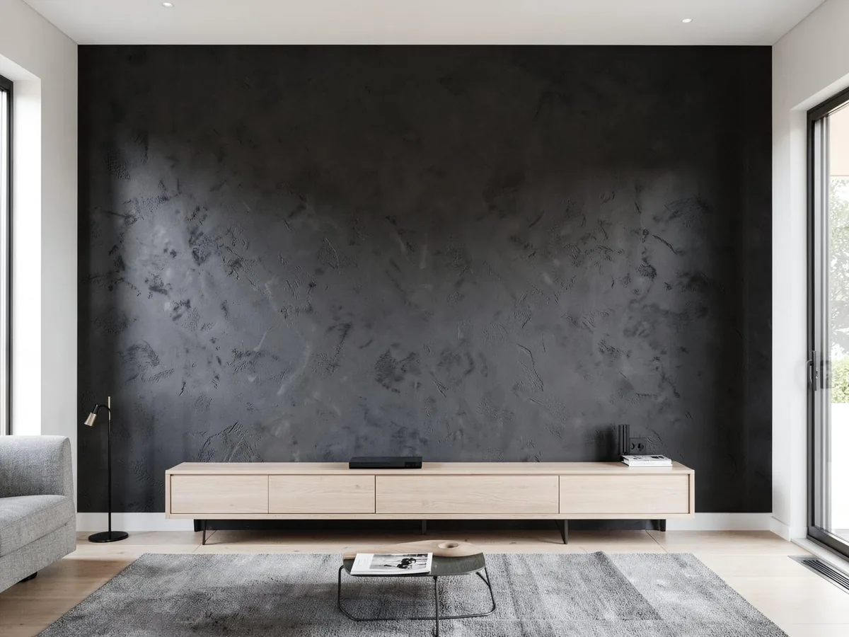 Charcoal textured plaster feature wall behind a low timber cabinet in a modern living room