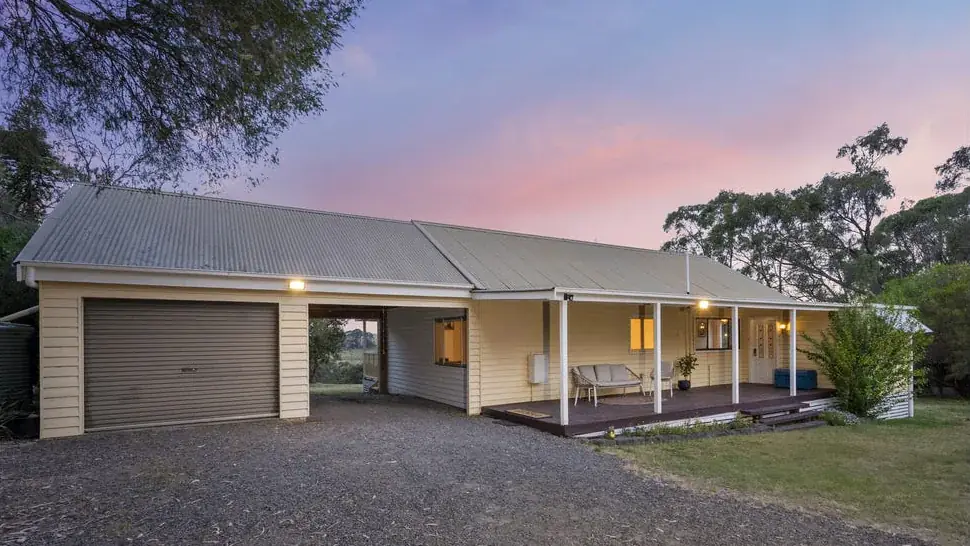 Front of a regional residential weatherboard home with verandah and driveway in Lauriston, Victoria