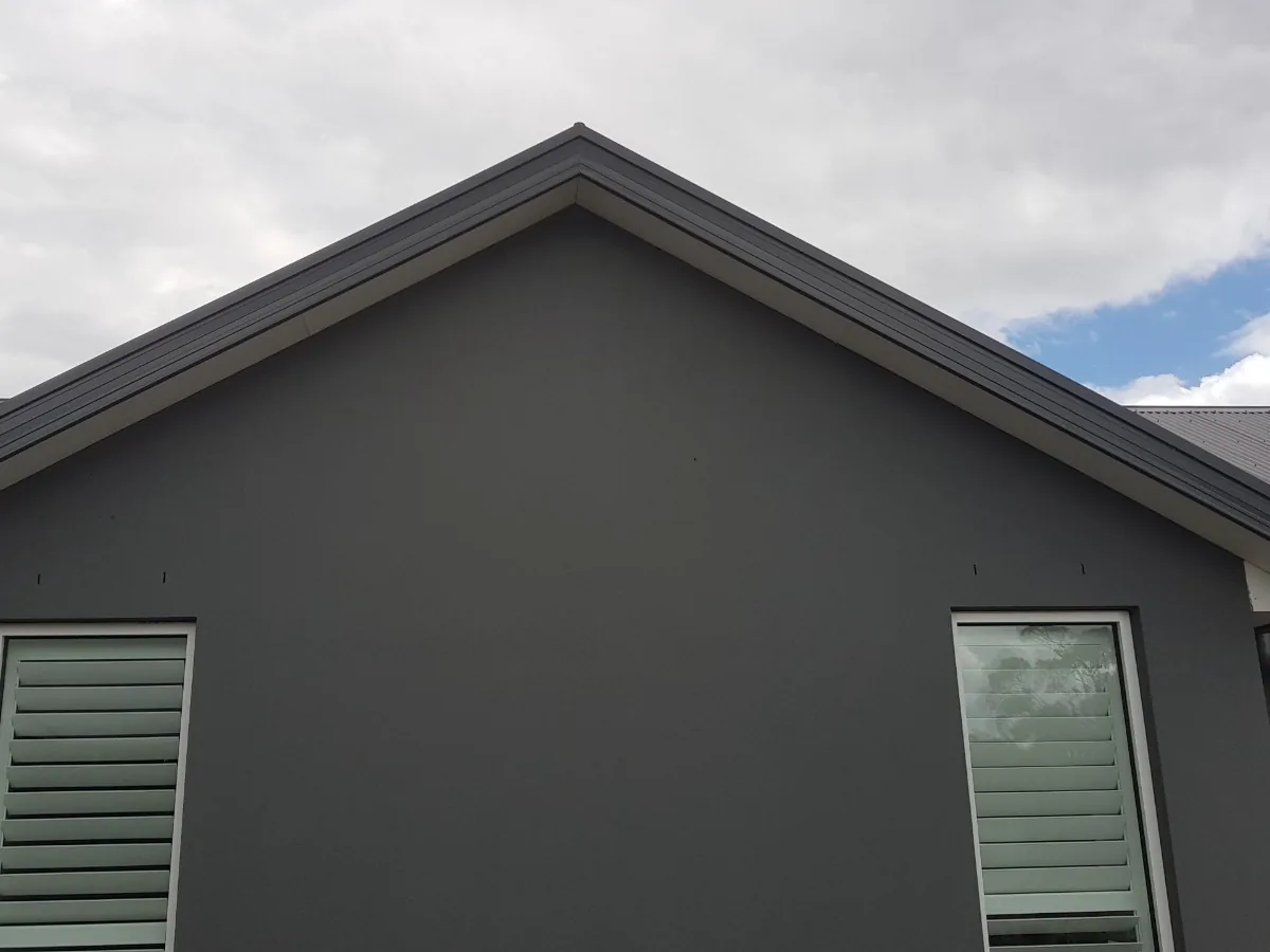 Close-up of a completed dark rendered gable on a residential home