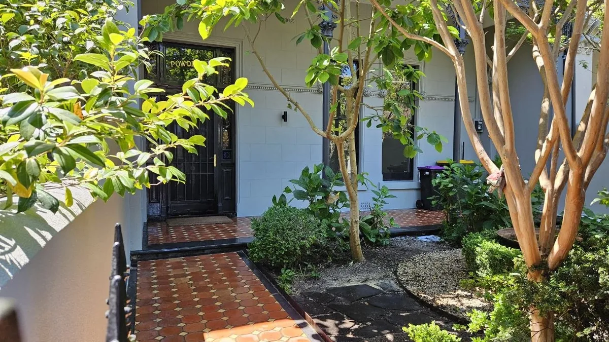 Heritage residential facade with restored render, decorative stencil detailing and exterior painting completed by BMR