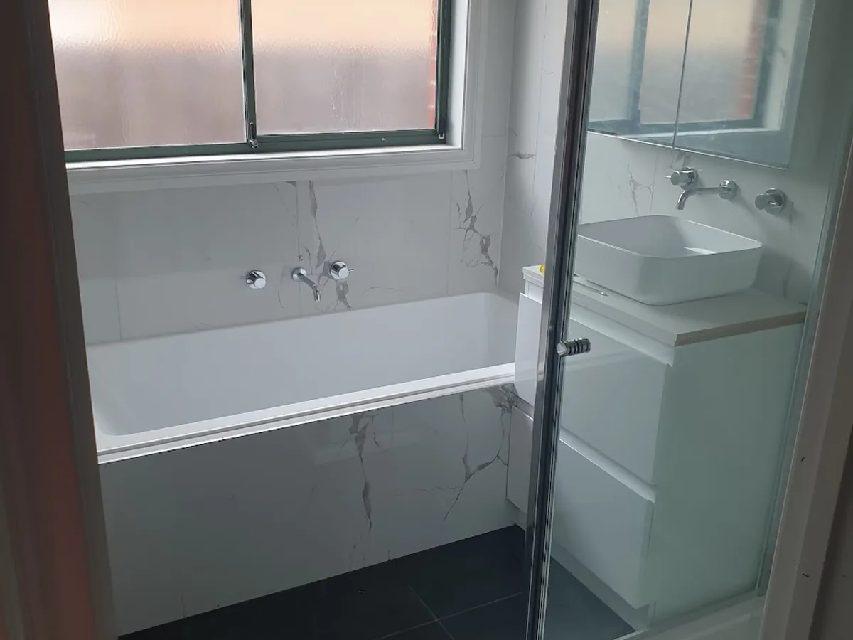 Completed bathroom renovation in Bendigo — freestanding bath, vanity and tiled shower with chrome fittings