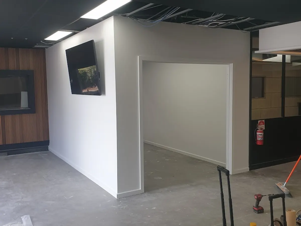 Plastering works in progress on a Bendigo renovation — set-out, tooling and re-sheeted walls in a dust-sealed space